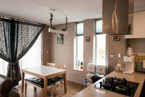 a kitchen with a table and a dining room at The Stay Christmas in Jeju