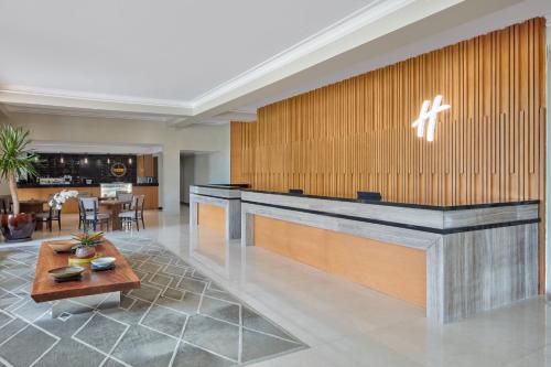 a lobby of a hotel with a reception desk at Holiday Inn & Suites Batangas LimaPark by IHG in Batangas City