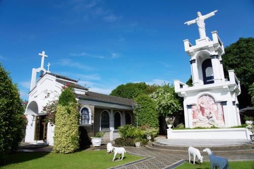 a church with sheep standing in front of it at Holiday Inn & Suites Batangas LimaPark by IHG in Batangas City