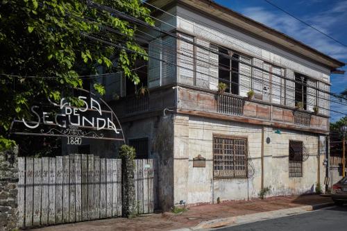 an old building with a sign on the side of it at Holiday Inn & Suites Batangas LimaPark by IHG in Batangas City