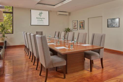 a conference room with a wooden table and chairs at Holiday Inn & Suites Batangas LimaPark by IHG in Batangas City
