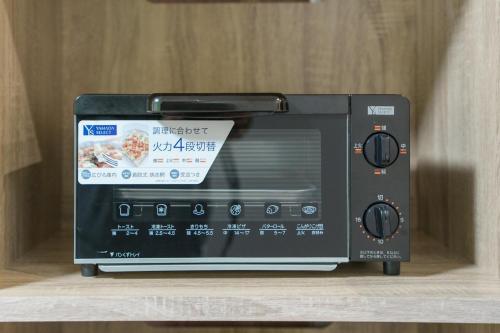 a black toaster oven sitting on top of a shelf at Room 201 - Itabashi Minamicho - Diamond Yu in Tokyo