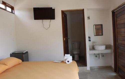 a bedroom with a bed with a basketball on the wall at BM Zihua Casa de Huéspedes in Zihuatanejo
