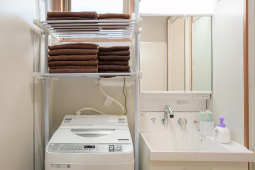 a bathroom with a washing machine and a sink at Room 201 - Itabashi Minamicho - Diamond Yu in Tokyo