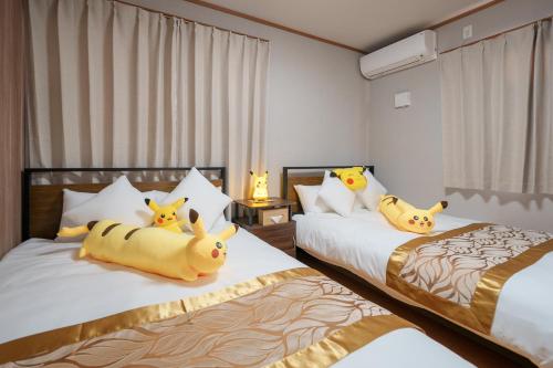 a bedroom with two beds with stuffed animals on them at Room 201 - Itabashi Minamicho - Diamond Yu in Tokyo