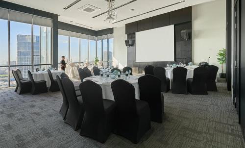 a conference room with a table and chairs and a person at Luxcity Hotel & Apartment in Phnom Penh