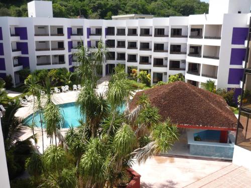 an aerial view of a hotel with a pool and palm trees at Hotel Debliz in Campeche