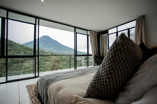 a bedroom with a bed with a view of a mountain at Sky Dancer Villa in Antigua Guatemala