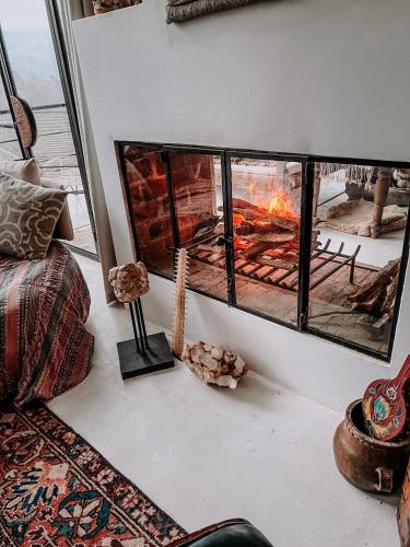 a fireplace in a living room with a fire place at Sky Dancer Villa in Antigua Guatemala