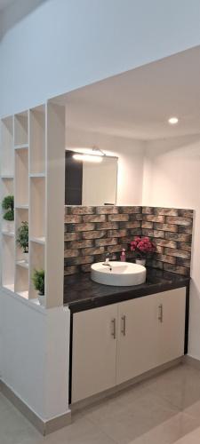 a bathroom with a white sink and a counter at Rockland Holidays in Ramakkalmedu