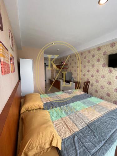 a bedroom with a large bed with a large mirror at SkyView Apartment By Kayu Lawang in Sunggal