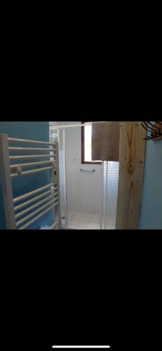 a kitchen with a white refrigerator and a door at Maison de vacances in Saint-Trojan-les-Bains