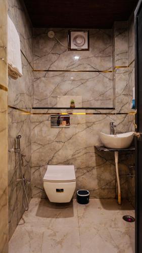 a bathroom with a toilet and a sink at River Town Stays in Varanasi