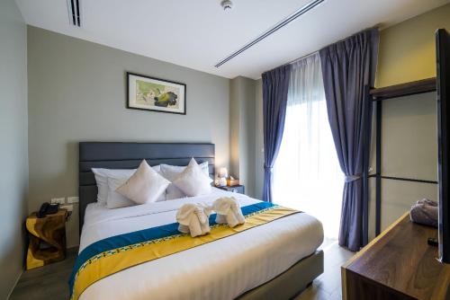 Katil atau katil-katil dalam bilik di Kana Triple L Hotel Phuket普吉岛卡娜3L酒店