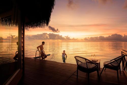 a group of people standing on a dock in the water at Mercure Maldives Kooddoo - Adults - Only Escape - 50 percent off Transfers in Gaafu Alifu Atoll