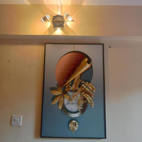 a picture of a wreath on a wall with a light at Wolf Cabins 2 in Nyeri