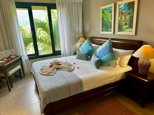 a bedroom with a bed with a bow on it at Eden Island Luxury Accommodation in Eden Island