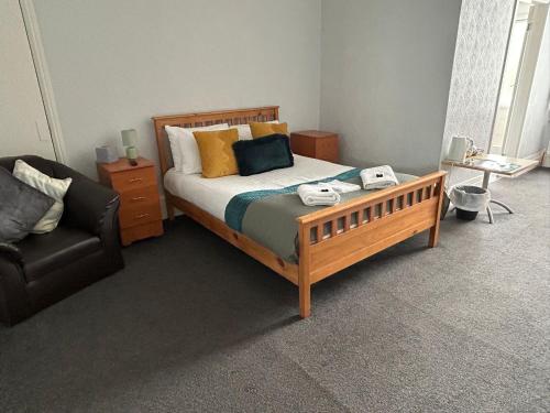 a bedroom with a bed and a couch and a chair at The Wheatley Hotel in Doncaster