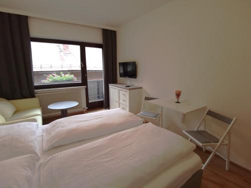 a hotel room with a bed and a window at Schlossalm Appartement in Bad Hofgastein