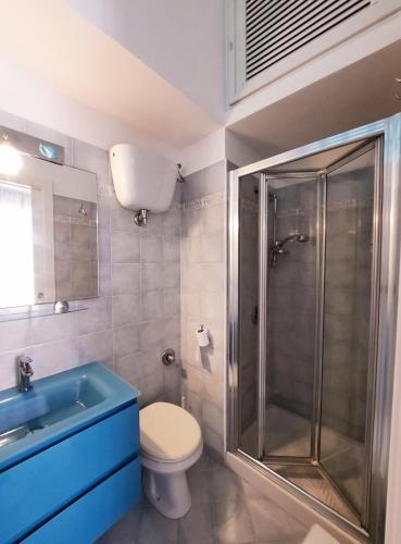 a bathroom with a shower and a toilet and a sink at Casa Simonetta il Roseto in Ponza
