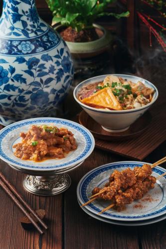a table with three plates of food and a bowl of food at City Hotel Xiamen-Free Welcome Fruits in Xiamen
