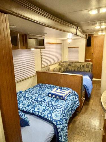 a room with two beds and a tub in it at Rooms in Modern RV Trailer Home in Los Angeles