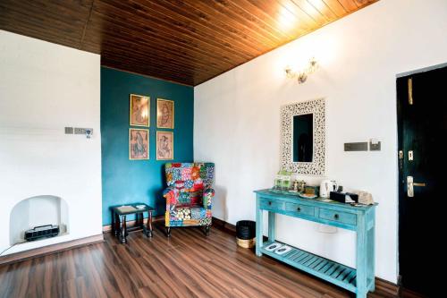 a room with a blue table and a chair at The Temi Bungalow South Sikkim in Namchi