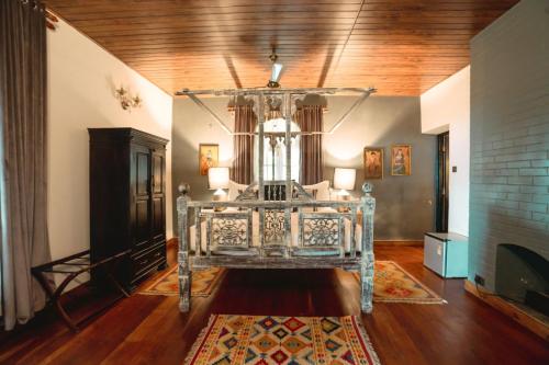 a bedroom with a bed in a room with a fireplace at The Temi Bungalow South Sikkim in Namchi