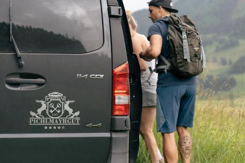 two people standing in the back of a van at Hotel Pichlmayrgut in Schladming