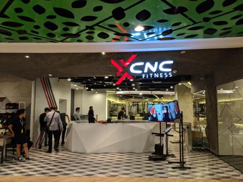 a cng times store with people standing around a table at The All - Suite Pentacity Hotel Balikpapan in Balikpapan