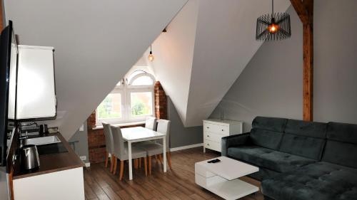 a living room with a couch and a table at Vintageapartment in Sopot