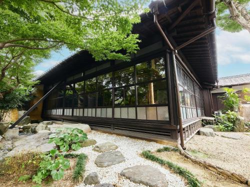 a house with a large window on the side of it at 以久波別邸虎屋 in Ukiha
