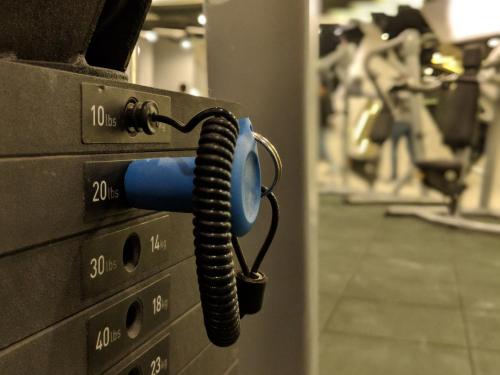 a phone is attached to a gym machine at The All - Suite Pentacity Hotel Balikpapan in Balikpapan