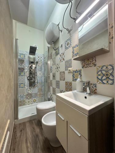a bathroom with a sink and a toilet and a shower at civico 44 in Bova Marina