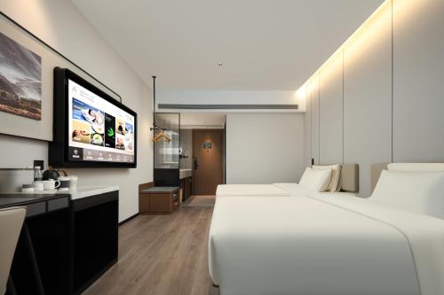 Ένα ή περισσότερα κρεβάτια σε δωμάτιο στο Atour Hotel Quanzhou Dehua