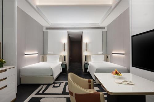 a hotel room with two beds and a table at Crowne Plaza Suzhou East Taihu by IHG in Suzhou