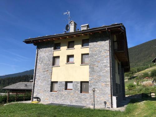 a building with a clock tower on top of it at Le Bouvier in Doues