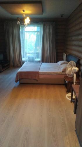 a bedroom with a large bed in a room at Pastoral wooden hauses in Velikiy Les