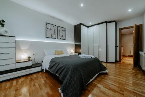 a bedroom with a large bed and a wooden floor at Logroño Premium Home in Logroño