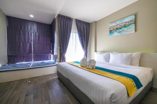 Katil atau katil-katil dalam bilik di Kana Triple L Hotel Phuket普吉岛卡娜3L酒店