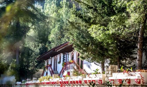 a house with trees in front of it at Hotel Castle Park in Berat