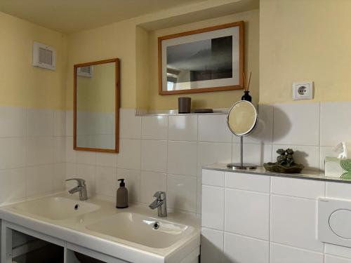 a white bathroom with a sink and a mirror at Sonnenhof Wildkatta Frühstückspension in Raabs an der Thaya