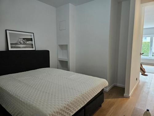 a bedroom with a bed in a white room at Centre de Bruxelles Merveilleux ! in Brussels