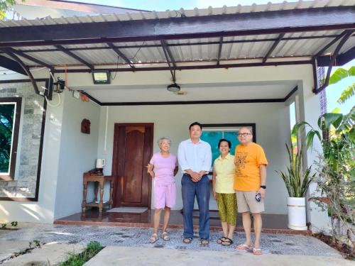 a group of people standing in front of a house at Primprey Second Home in Battambang