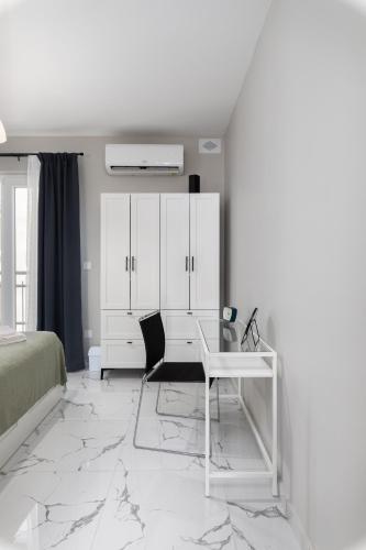 a white bedroom with a desk and a bed at Modern 2BR Cosy Apartment with Large Terrace - Close to Manoel Island & Tigne Shopping Mall in Sliema