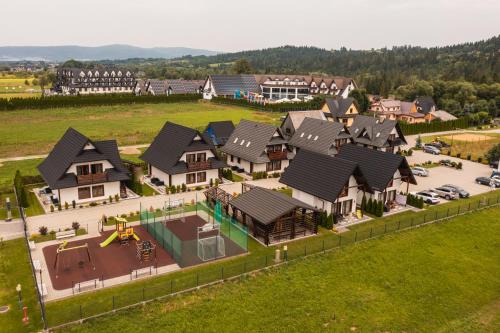 an overhead view of a house with a playground at Apartamenty, pokoje PRZY TERMACH - 70 m Termy Szaflary, 150 m Gorący Potok in Szaflary
