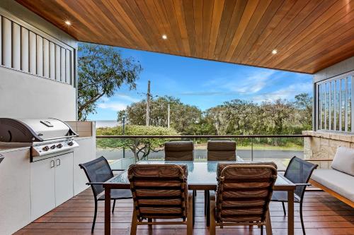 a kitchen and dining room with a table and chairs at Driftwood Retreat in Quindalup