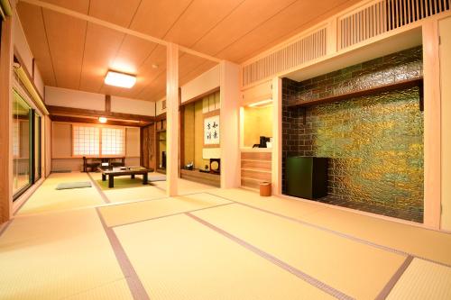 a living room with a large screen tv in a building at Koyasan Shukubo Jokiin in Koyasan