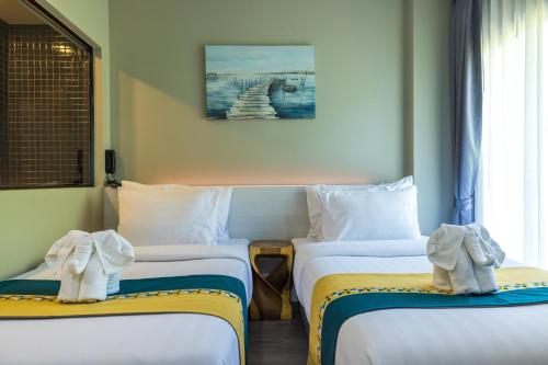 Katil atau katil-katil dalam bilik di Kana Triple L Hotel Phuket普吉岛卡娜3L酒店