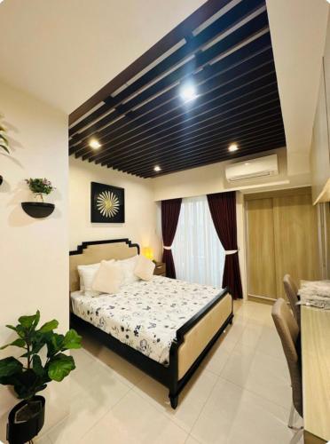 a bedroom with a bed in a room at Inspiria Cozy Condo in Cabaguio